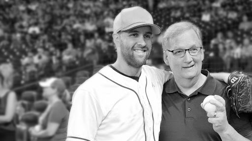 科林·麦克休在一场棒球比赛中搂着他的父亲——一位前列腺癌幸存者