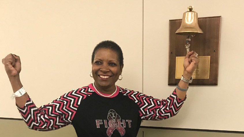 Breast cancer survivor Cheryl Ratliff rings the bell to mark the end of her treatment