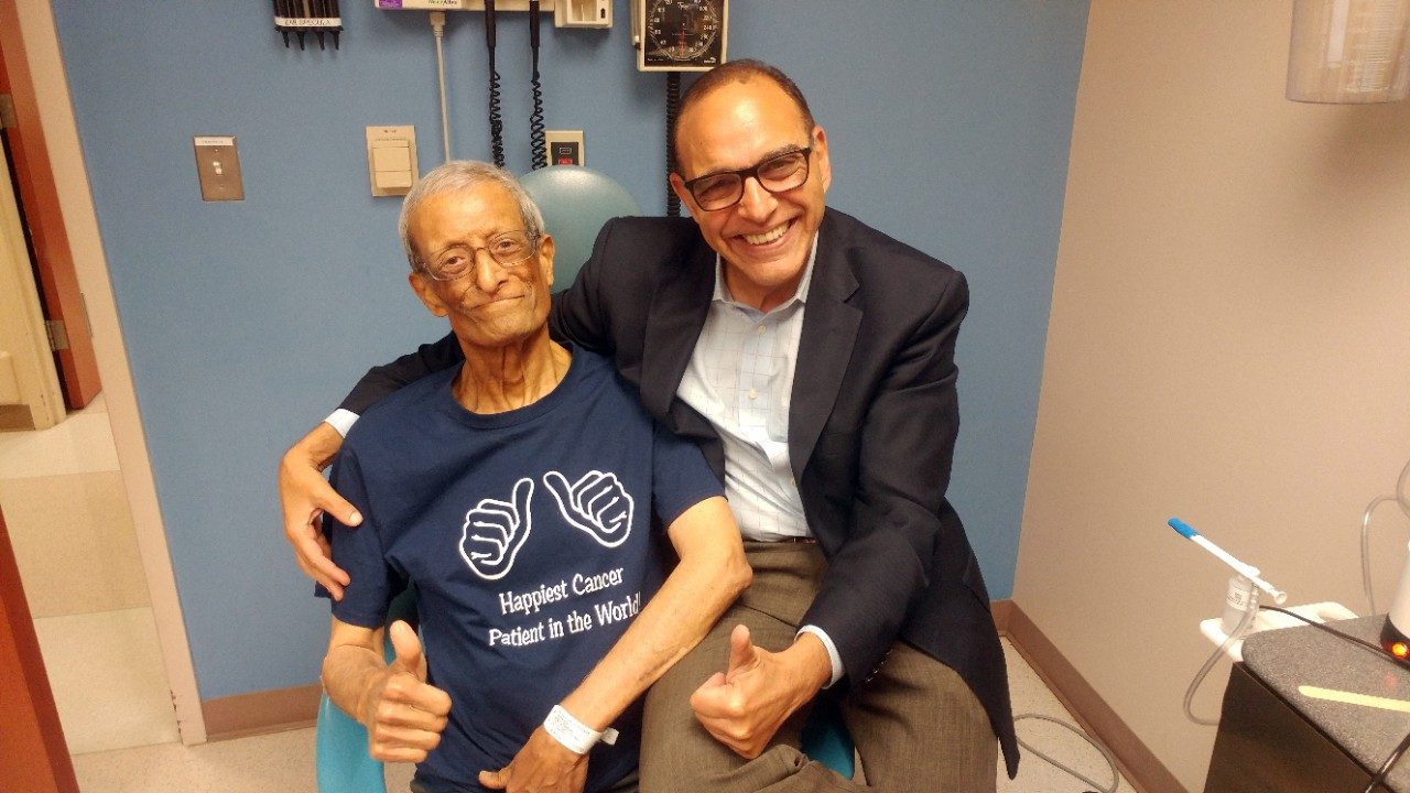 Oral cancer survivor Adel Tawfik poses with Ehab Hanna, M.D., after successful treatment.