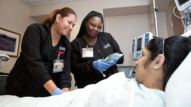 Jaquelin Velasquez，Left，Misha Hawkins在用汽车T细胞注入患者之前执行双护士验证过程。