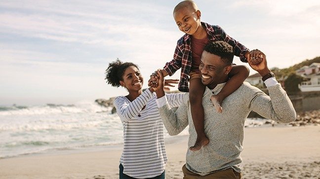 Black couple on the beach with their child