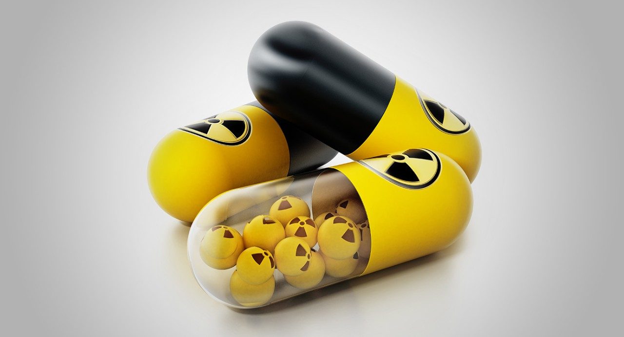 带有放射性警告符号的黄色/黑色药物胶囊的风格化描述