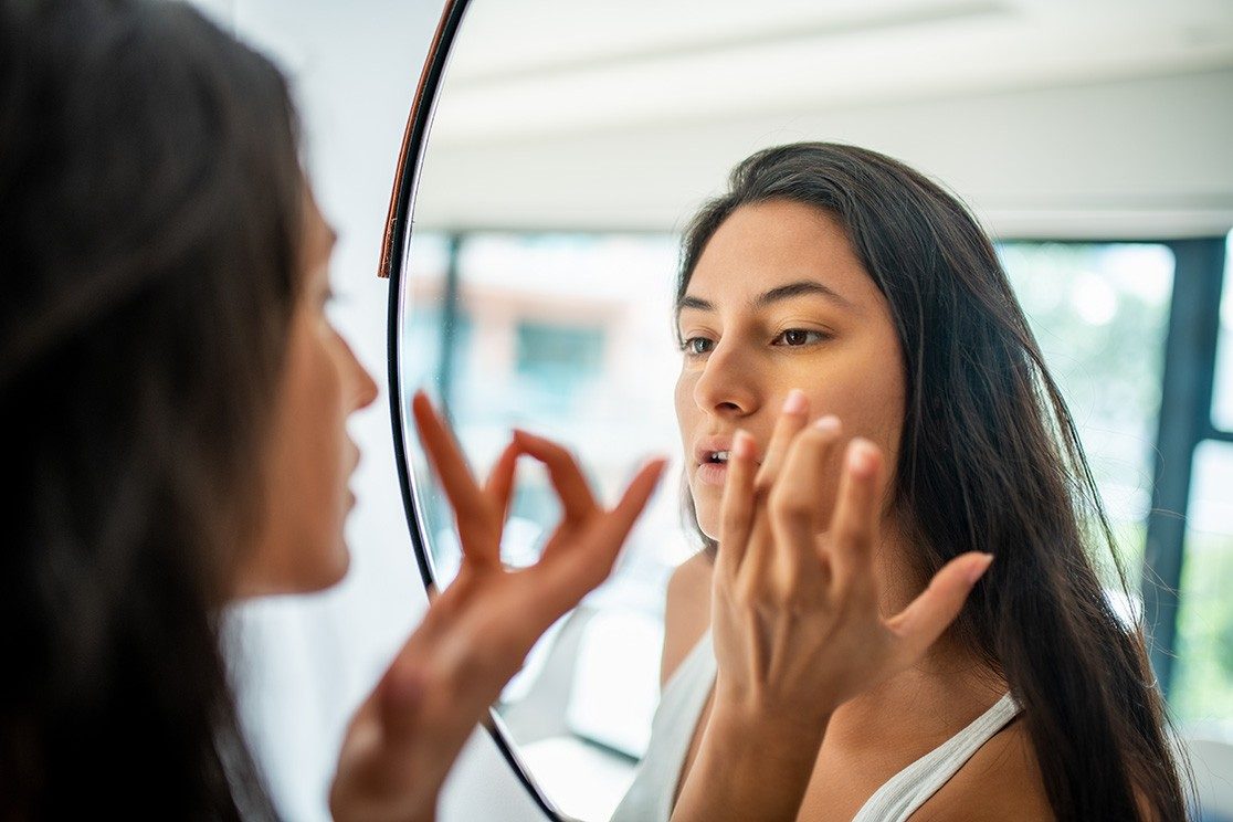 女人用镜镜检查皮肤